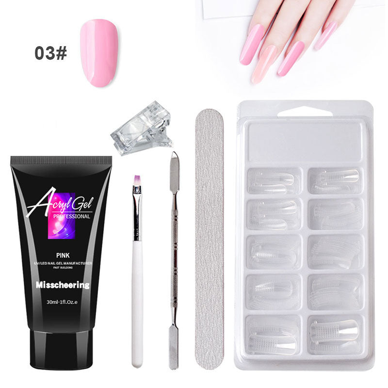 Woman applying acrylic nail extension using professional nail brush from complete kit.